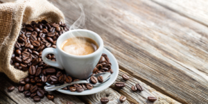 Cup of coffee with spoon and coffee beans